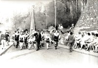 Photographie des Chinels et de leur porte-drapeau lors de leur déplacement à Binche en 1976